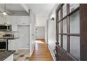 Kitchen and hardwood floors seen from entryway with vintage door at 2301 Drew Valley Ne Rd, Brookhaven, GA 30319