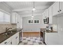 Modern kitchen with granite counters, white cabinets, and tile floor at 2301 Drew Valley Ne Rd, Brookhaven, GA 30319