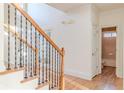 Hallway with hardwood floors, iron railing, and a view of the bathroom at 3184 Islesworth Trce, Duluth, GA 30097