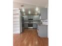 Bright kitchen features gray cabinetry, stainless steel appliances, recessed lighting, and wood flooring at 220 Canterbury Ln, Lawrenceville, GA 30046