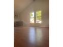 Bright and spacious living room with wood flooring, a large window, and a built-in desk at 220 Canterbury Ln, Lawrenceville, GA 30046