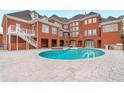 Large kidney shaped pool, brick patio, hot tub, and grilling area at 2280 Wilshire Dr, Grayson, GA 30017