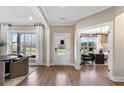 Bright entryway with a white front door, large windows, and hardwood floors at 5270 Birch Valley Rd, Cumming, GA 30028