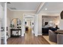 Bright entryway with hardwood floors, an arched mirror, and views into the living areas beyond at 5270 Birch Valley Rd, Cumming, GA 30028