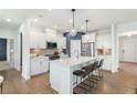 Modern kitchen featuring white cabinetry, stainless steel appliances, and a center island with bar stool seating at 5270 Birch Valley Rd, Cumming, GA 30028