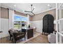 Home office with a large window, a dark desk, and a modern light fixture at 5270 Birch Valley Rd, Cumming, GA 30028