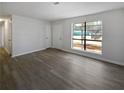 Bright living room with grey vinyl plank flooring and large windows at 9129 Bent Pine Ne Ct, Covington, GA 30014