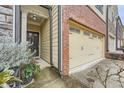 Inviting entrance featuring a brick facade and a convenient two-car garage at 162 Townview Dr, Woodstock, GA 30189