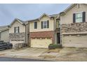 Charming townhouse featuring a brick facade and a convenient two-car garage at 162 Townview Dr, Woodstock, GA 30189