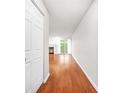 Hardwood floor entry hall with closet and view to living room at 23 Chelsea Ct, Avondale Estates, GA 30002