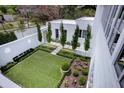 Landscaped backyard with a manicured lawn and decorative plants at 3770 Peachtree Ne Rd, Atlanta, GA 30319