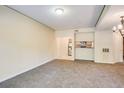 Bright living room boasts neutral paint, comfortable carpeting, and a view of the adjacent kitchen area at 1250 Parkwood Se Cir # 1004, Atlanta, GA 30339