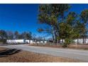 Commercial property with a gated entrance and surrounding trees at 200 Heath Rd, Carrollton, GA 30116