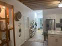 Bright hallway with exposed wooden beams, leading to kitchen and other rooms at 200 Heath Rd, Carrollton, GA 30116