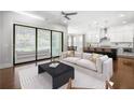 Open-concept living room and kitchen featuring a sliding glass door to the outside at 6540 Namon Creek Trl, Cumming, GA 30028
