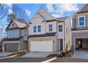 Two-story home with gray siding, stone accents, and a two-car garage at 714 Smokey Quartz Way, Kennesaw, GA 30144