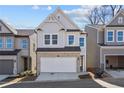 Two-story home with gray siding, stone accents, and a two-car garage at 714 Smokey Quartz Way, Kennesaw, GA 30144