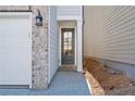 Side entrance with gray door and brick walkway at 714 Smokey Quartz Way, Kennesaw, GA 30144
