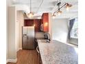 Modern kitchen with stainless steel appliances and wood cabinets at 32 Peachtree Nw St # 308, Atlanta, GA 30303
