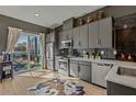 Modern kitchen with gray cabinets, stainless steel appliances, and a sliding glass door to the outside at 2199 Lenox Ne Rd # 13, Atlanta, GA 30324