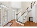 Two-story foyer with hardwood floors and elegant staircase at 135 Eagles Club Dr, Stockbridge, GA 30281