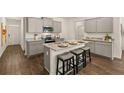 Modern eat-in kitchen features stainless appliances, granite countertops and island seating at 2458 Bayberry St, Acworth, GA 30101