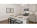 Modern eat-in kitchen features stainless appliances, granite countertops and island seating at 2458 Bayberry St, Acworth, GA 30101