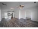 Open concept living room with kitchen views and hardwood floors at 1416 Oglethorpe Sw Ave, Atlanta, GA 30310