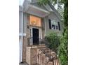 Inviting front entrance with brick stairs and a black door, bathed in natural light at 571 Oak Vista Ct, Lawrenceville, GA 30044