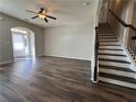 Living room with hardwood floors, a fireplace, and access to stairs leading upstairs at 2101 Summer Wind Sw Dr, Marietta, GA 30060