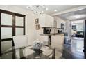 Glass-topped dining table with four chairs, in an open floor plan at 1385 Kenilworth Sw Dr, Atlanta, GA 30310