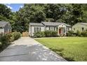 House with a driveway and a lush green lawn at 1385 Kenilworth Sw Dr, Atlanta, GA 30310