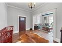 Stylish foyer with hardwood floors, decorative doorway and a peek into the cozy living space at 2507 Maple St, Atlanta, GA 30344