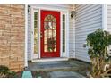 Two-story house with stone accents and a red front door at 4160 Alveston Dr, Atlanta, GA 30349
