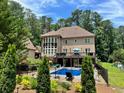Inviting backyard oasis with a swimming pool, deck, and lush landscaping at 1891 Prospect Church Rd, Lawrenceville, GA 30043