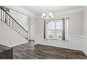 Bright dining room with wainscoting, hardwood floors, and a large window at 66 Vicky Way, Douglasville, GA 30134