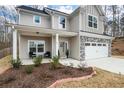 Two-story house with front porch, landscaping, and a stone facade at 66 Vicky Way, Douglasville, GA 30134