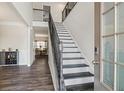 Elegant staircase with dark wood and metal railing leading to the second floor at 66 Vicky Way, Douglasville, GA 30134
