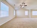 Spacious main bedroom with high ceilings, carpeted floors, and multiple windows at 585 Briarhurst Ct, Lawrenceville, GA 30046