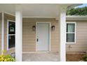 Inviting front porch entryway with gray door and white columns at 6945 Brown S Dr, Fairburn, GA 30213