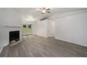 Spacious living room featuring hardwood floors and a fireplace at 6945 Brown S Dr, Fairburn, GA 30213