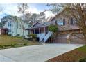 Two story house next to a light beige house with a view of the street at 1129 Gate Post Ln, Lawrenceville, GA 30044