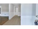 Bright entryway with tile flooring and white wainscoting at 1129 Gate Post Ln, Lawrenceville, GA 30044