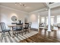 This formal dining room features hardwood floors and transitions into a naturally lit living space at 6355 Indian Acres Trl, Tucker, GA 30084