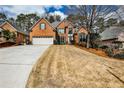 Traditional two-story brick home featuring a well-manicured lawn and attached two-car garage at 6355 Indian Acres Trl, Tucker, GA 30084