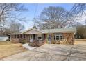 Attractive single-story house featuring a unique stone accent wall and a large, paved driveway at 1155 Casteel Rd, Powder Springs, GA 30127