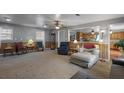 Bright living room area with wood trim, a ceiling fan and backyard views at 1155 Casteel Rd, Powder Springs, GA 30127