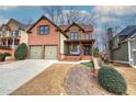 Two-story home with brick and stone exterior, two-car garage, and landscaped yard at 233 Yorkshire Ln, Villa Rica, GA 30180