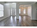 Open living area with gray wood-look floors and view to dining room and kitchen at 233 Yorkshire Ln, Villa Rica, GA 30180