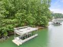 A two-story dock sits in the water, with upper deck furniture, stairs, and access to the lake at 6006 Lanier Heights Cir, Buford, GA 30518